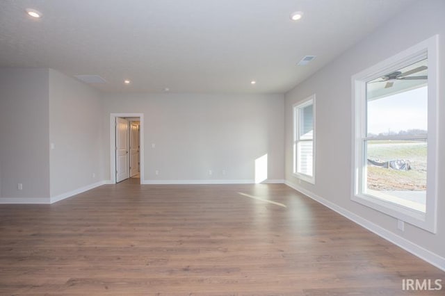 empty room with hardwood / wood-style floors and ceiling fan