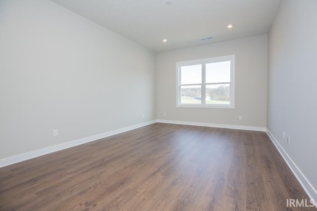 empty room with dark hardwood / wood-style flooring