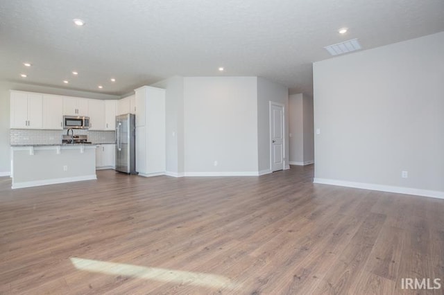 unfurnished living room featuring light hardwood / wood-style floors