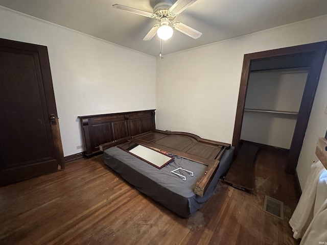 bedroom with ceiling fan and dark wood-type flooring