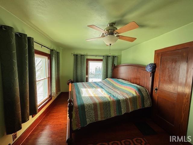 bedroom featuring dark hardwood / wood-style floors and ceiling fan