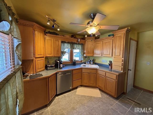 kitchen featuring stainless steel dishwasher, ceiling fan, and sink