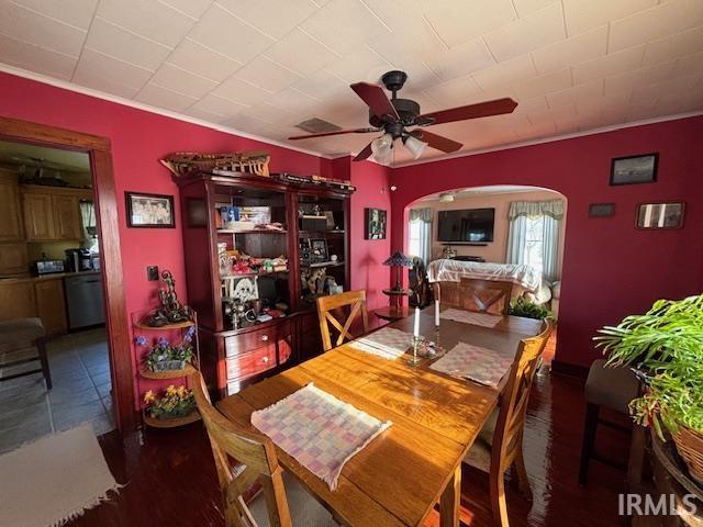 dining space featuring ceiling fan and ornamental molding