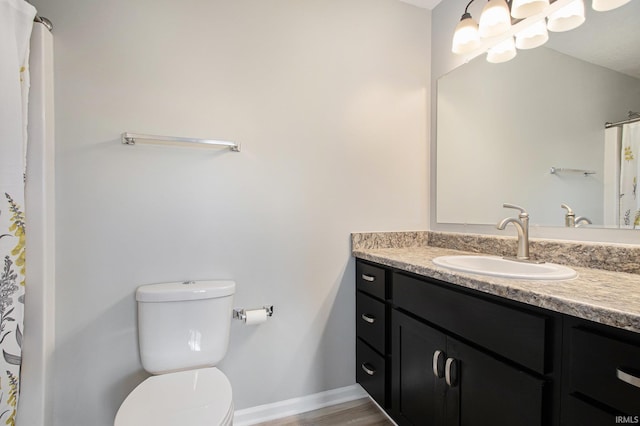 bathroom with hardwood / wood-style floors, vanity, and toilet