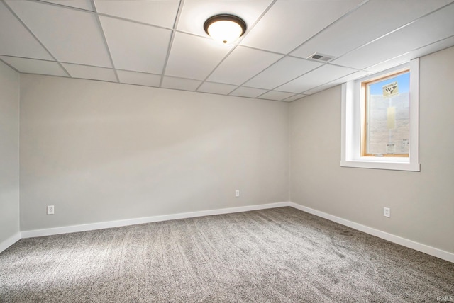 spare room with carpet and a drop ceiling