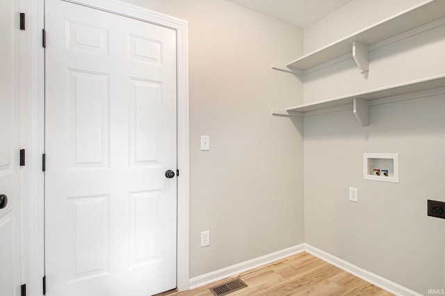 washroom featuring hookup for a washing machine, light wood-type flooring, and electric dryer hookup