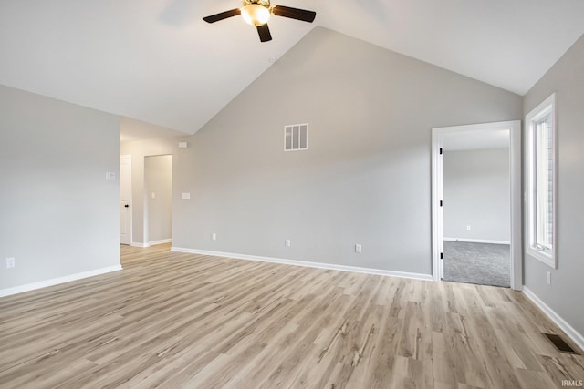 unfurnished living room with ceiling fan, light wood-type flooring, and high vaulted ceiling