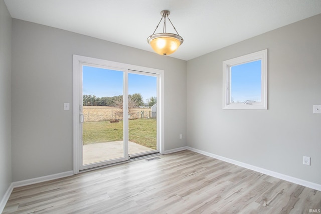 unfurnished room with light wood-type flooring