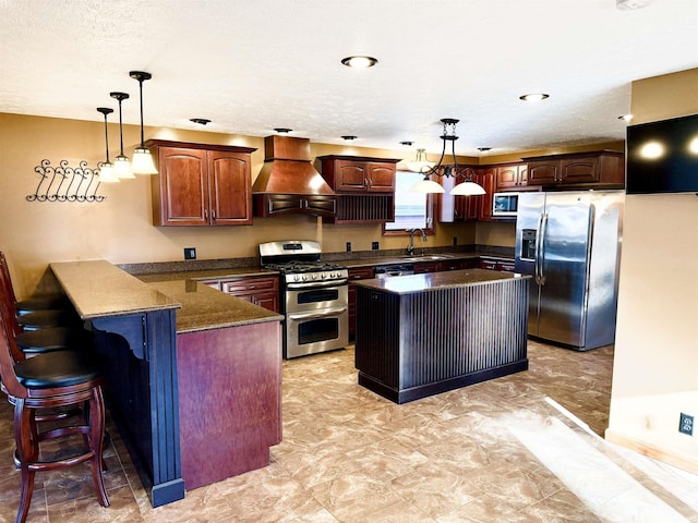 kitchen featuring premium range hood, a kitchen island, pendant lighting, and appliances with stainless steel finishes