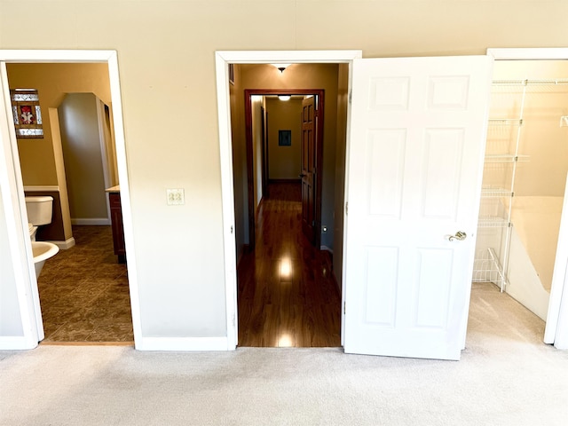 hall with light colored carpet