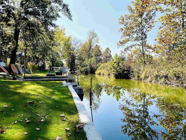 exterior space with a lawn and a water view