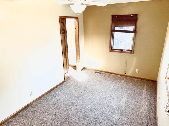 spare room featuring carpet and ceiling fan