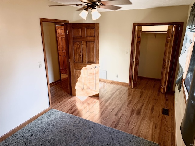 bedroom with ceiling fan, light wood-type flooring, and a closet