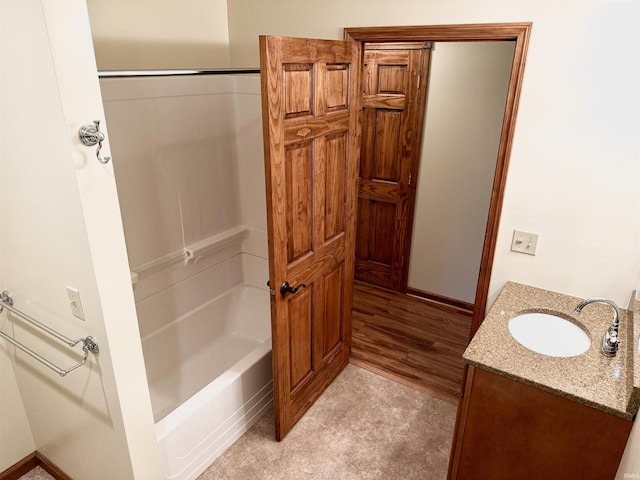 bathroom featuring vanity, shower / bathing tub combination, and wood-type flooring