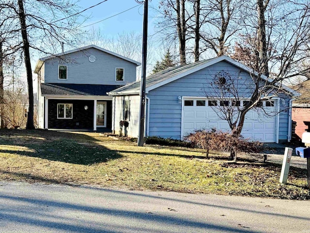 front of property featuring a front lawn and a garage