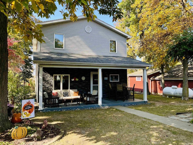 rear view of property featuring a lawn