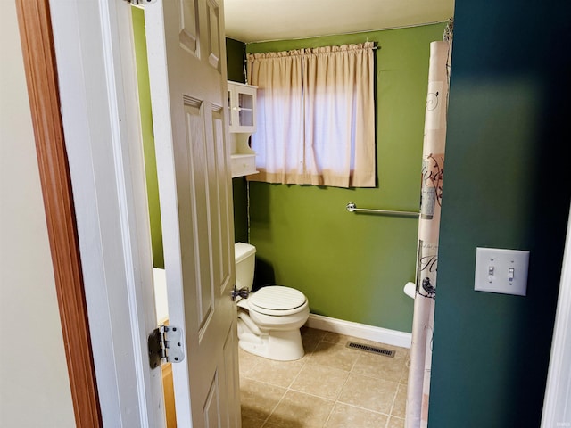 bathroom featuring tile patterned floors and toilet