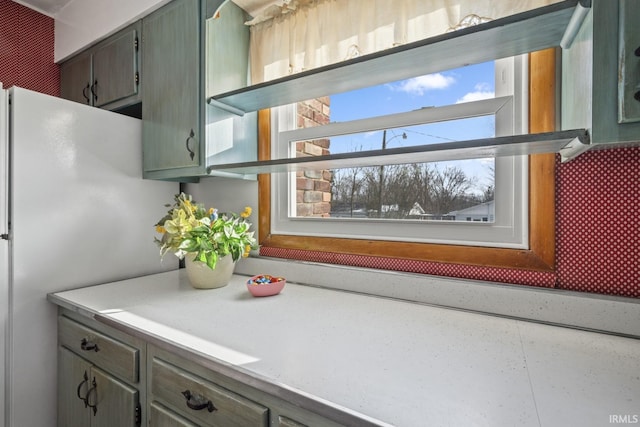 interior space with white refrigerator and plenty of natural light