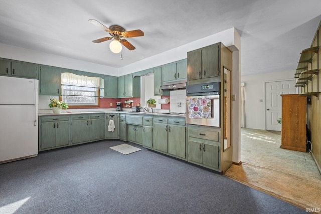 kitchen featuring stainless steel oven, green cabinets, white fridge, decorative backsplash, and ceiling fan