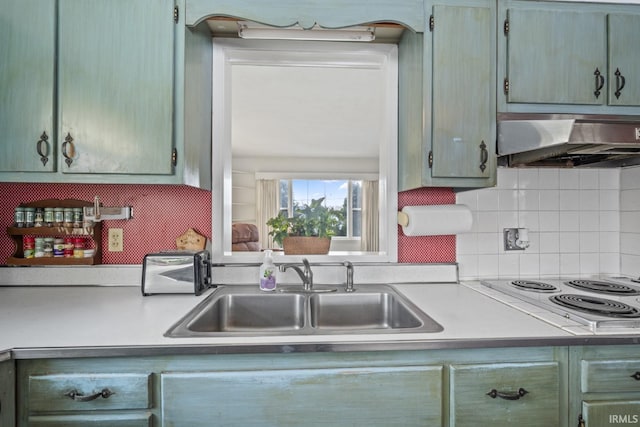 kitchen with sink, backsplash, and white electric cooktop