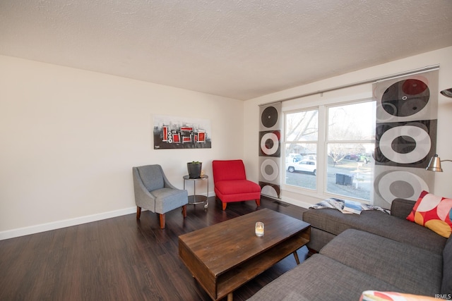 living room featuring dark hardwood / wood-style floors and a textured ceiling