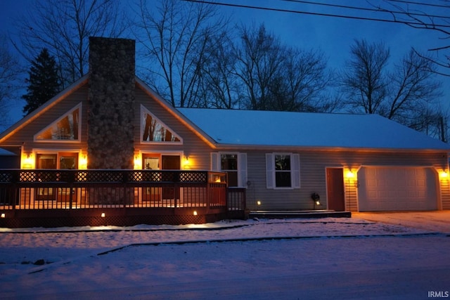 view of front of house featuring a garage and a deck