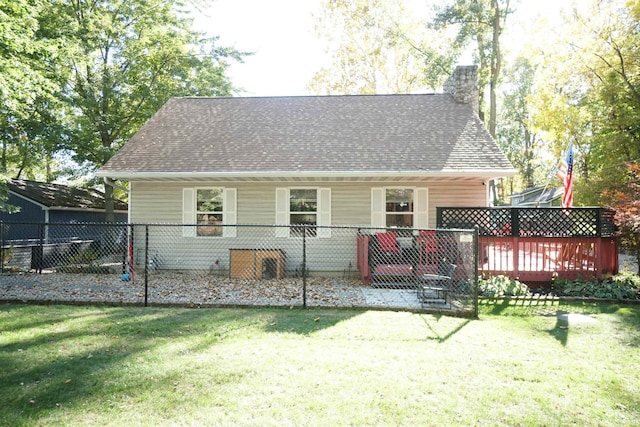 back of house featuring a deck and a lawn