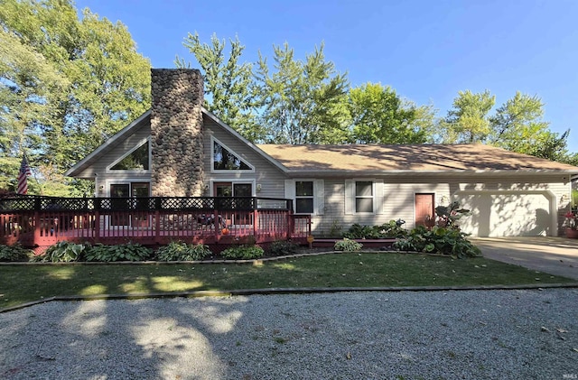 view of front facade featuring a front yard, a garage, and a wooden deck