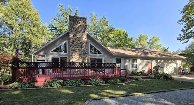 view of front of property featuring a garage, a deck, and a front yard