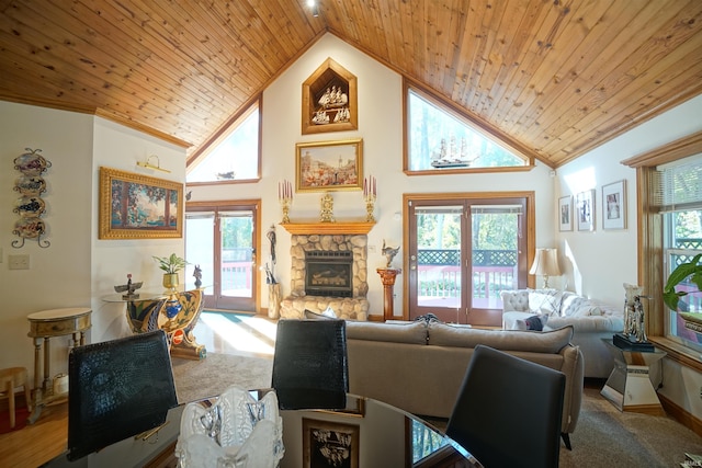 living room with a stone fireplace, wood ceiling, light carpet, and high vaulted ceiling