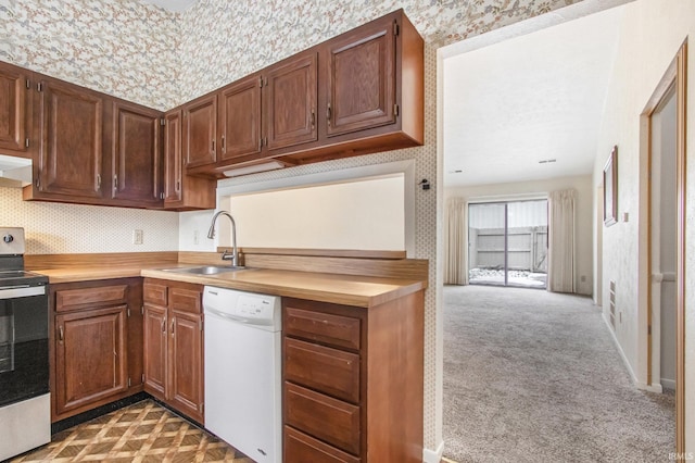 kitchen featuring dark colored carpet, dishwasher, stove, and sink