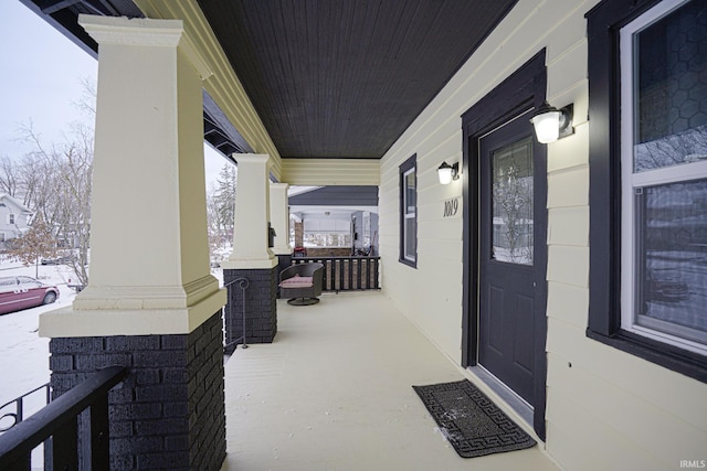 snow covered patio with covered porch