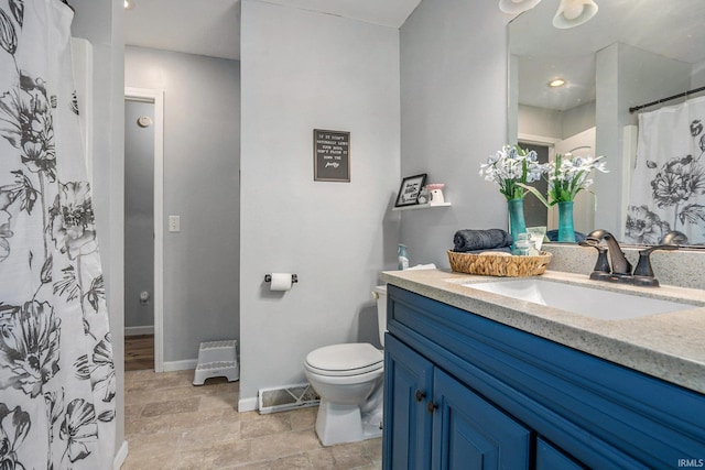 bathroom with vanity, toilet, and walk in shower