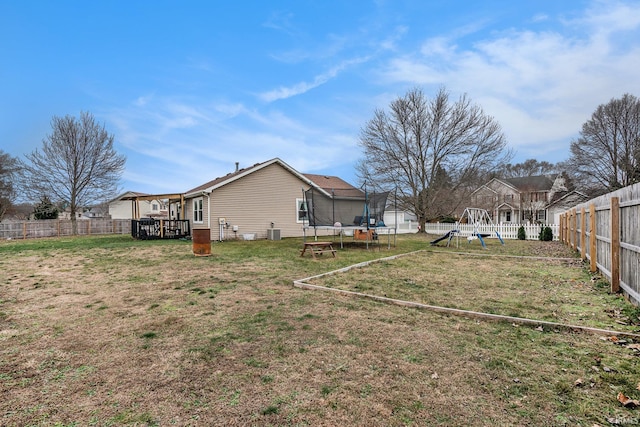 view of yard with a playground and a trampoline