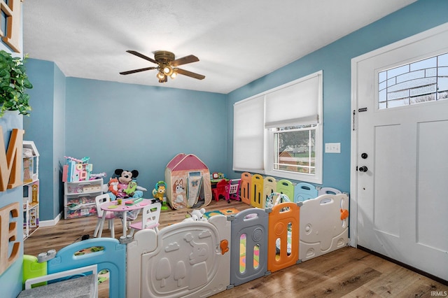 playroom featuring hardwood / wood-style floors and ceiling fan