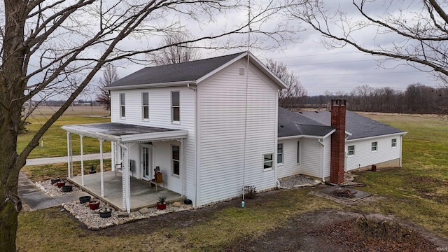 exterior space with covered porch and a yard