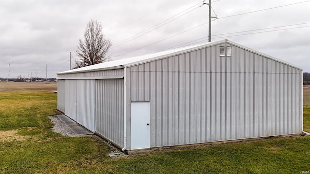 view of outbuilding featuring a yard