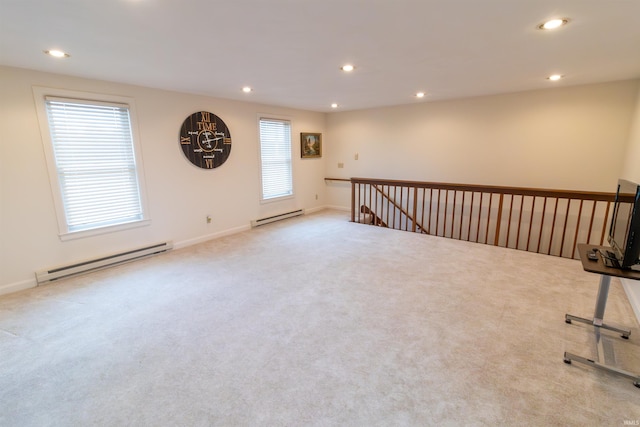 carpeted spare room with baseboard heating