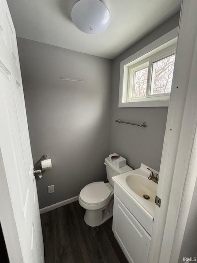 bathroom featuring hardwood / wood-style flooring, vanity, and toilet