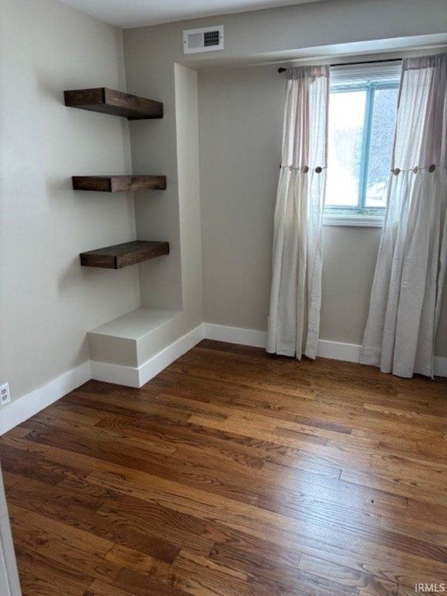 empty room featuring dark hardwood / wood-style flooring