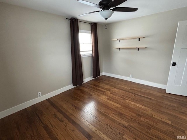 empty room with ceiling fan and dark hardwood / wood-style floors