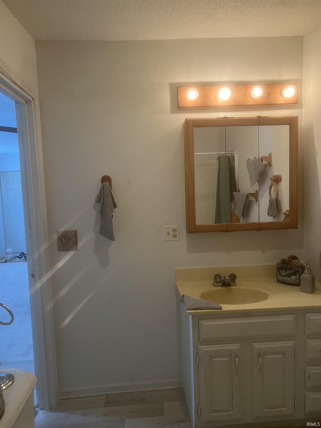 bathroom featuring vanity and a textured ceiling