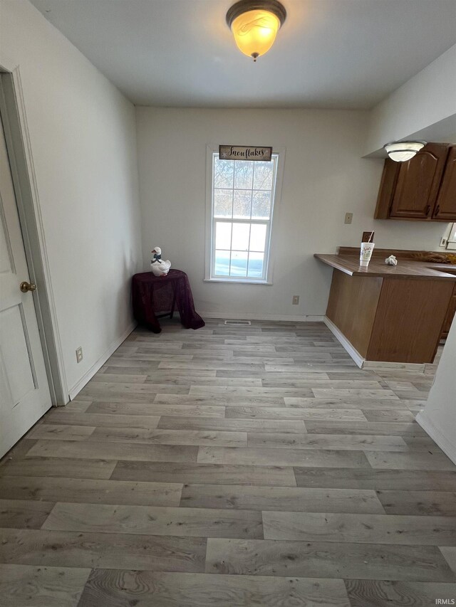 unfurnished dining area with light hardwood / wood-style floors