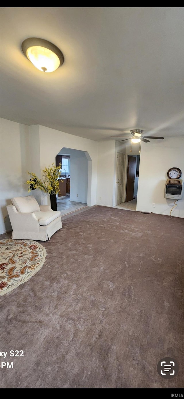 unfurnished living room featuring carpet and heating unit