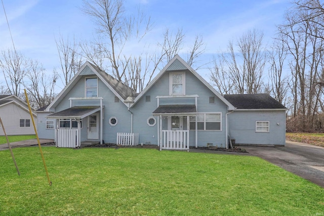 back of house with a lawn