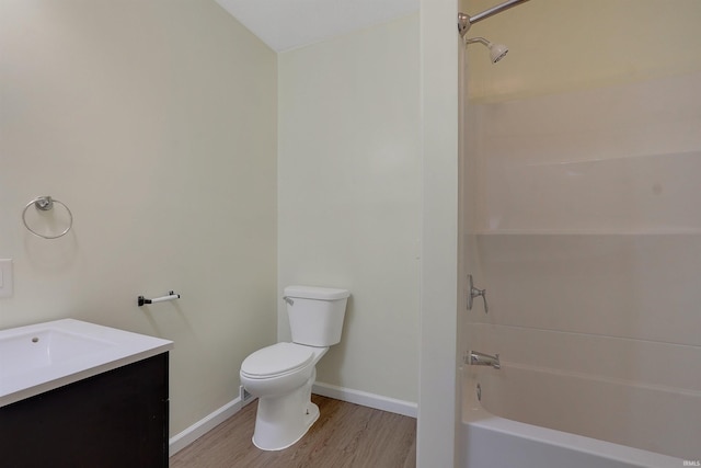 full bathroom with washtub / shower combination, hardwood / wood-style flooring, vanity, and toilet