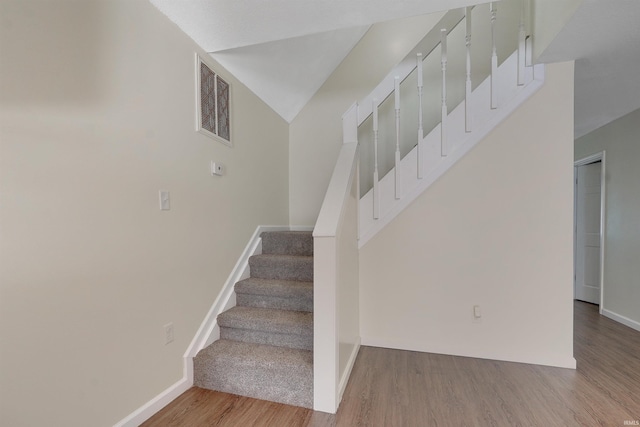 staircase featuring wood-type flooring