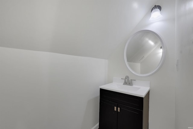 bathroom featuring vanity and vaulted ceiling