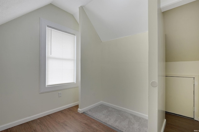 bonus room with dark hardwood / wood-style flooring and lofted ceiling