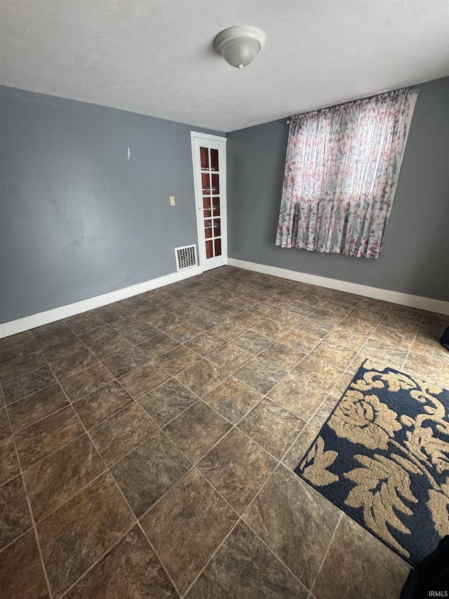 empty room with a textured ceiling